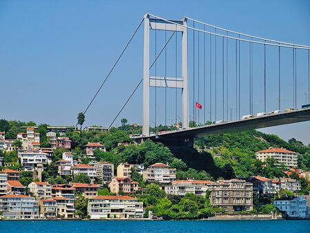 Istanbul Second Bosphorus bridge. View of the Fatih Sultan Mehmet Bridge and residental buildings from cruise ship sailing Bosporus.の写真素材