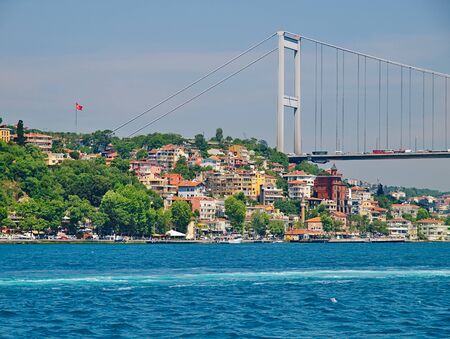 Istanbul Second Bosphorus bridge. View of the Fatih Sultan Mehmet Bridge and residental buildings from cruise ship sailing Bosporus.の写真素材