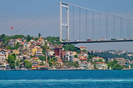 Istanbul Second Bosphorus bridge. View of the Fatih Sultan Mehmet Bridge and residental buildings from cruise ship sailing Bosporus.のeditorial素材