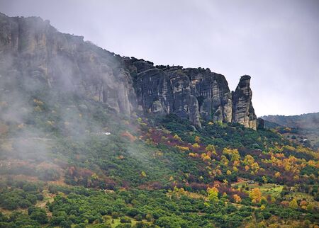 Meteora, Greece, winter dramatic landscape with heavy clouds and foggy mountains. Vibrant colorful nature.の写真素材