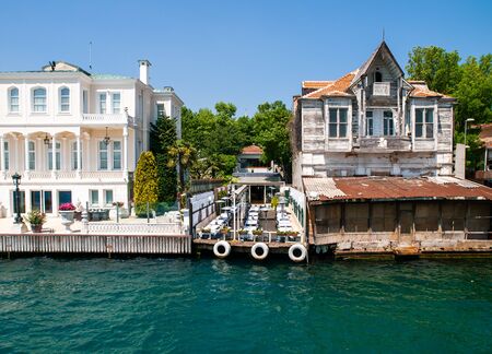 Yenikoy, Istanbul / Turkey -   Restaurant yard between abandoned  old wooden and luxurious maintained mansions  at Bosporus coast.の写真素材