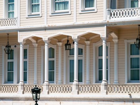 Wooden mansion close up detail. Beautiful classic architecture balcony with arch,  columns and many windows.の写真素材