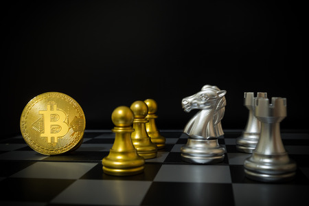 Business strategy ideas concept golden bitcoin and chess board game, symbolizes elements of virtual economy or crypto currencyの写真素材