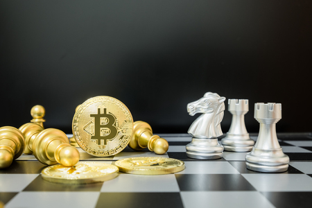 Business strategy ideas concept golden bitcoin and chess board game, symbolizes elements of virtual economy or crypto currencyの写真素材
