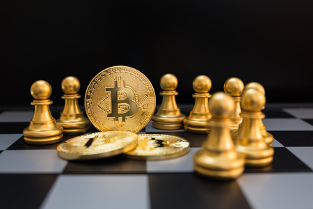 Business strategy ideas concept golden bitcoin and chess board game, symbolizes elements of virtual economy or crypto currencyの写真素材