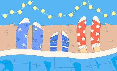Family spend time in bed in socks. dad, mom and child legs in socks during Christmas winter...