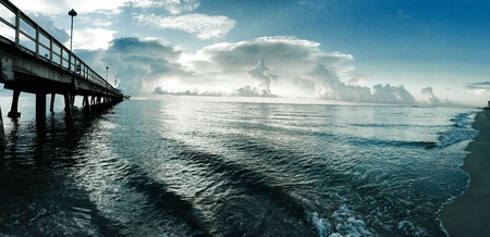 pier and the ocean with cloudy blue sky, Floridaの写真素材