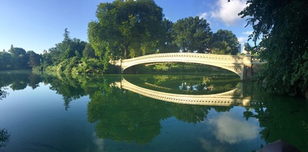 reflection of Bow bridge and trees at Central park, New Yorkの写真素材