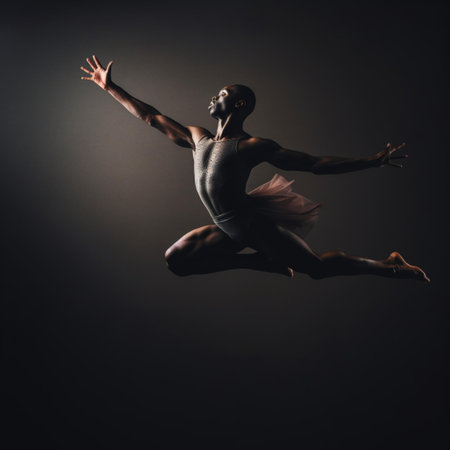 Full length portrait of a black male ballet dancer jumping in the studioの素材