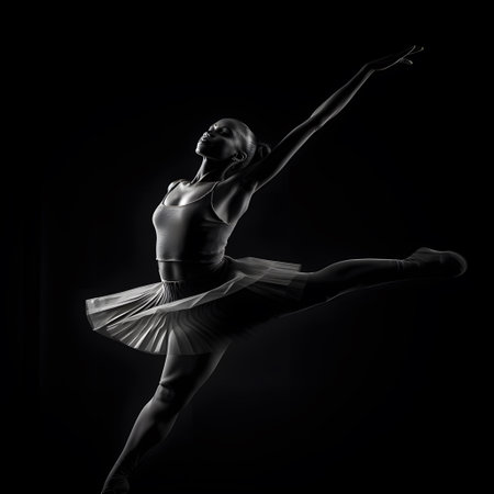 young beautiful ballerina posing on a black background in the studioの素材
