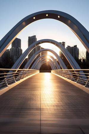 Pedestrian bridge over the river at sunset in the city.の素材