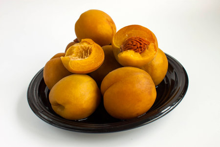 large ripe canned peaches on a dishの写真素材