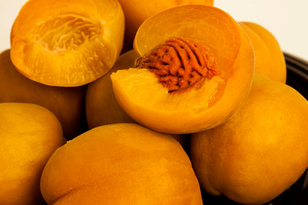 large ripe canned peaches on a dishの写真素材
