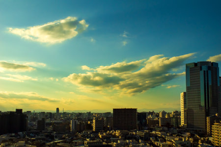 Images of sky, clouds, city and buildings, from daytime to sunsetの写真素材