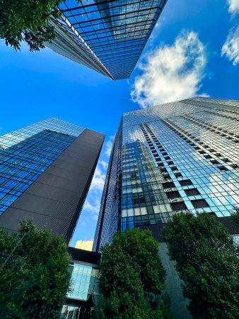 High-rise apartment building in the city, blue sky and white clouds, daytimeの写真素材