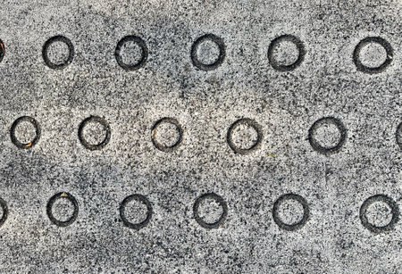 Cement floor with round holes. Abstract background and texture for design.の写真素材