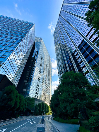 High-rise apartment building in the city, blue sky and white clouds, daytime, Shinjuku, Tokyo, Japanの写真素材
