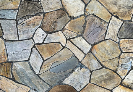 Fragment of a wall from a chipped stone. Abstract background for design.の写真素材