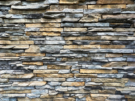 Background of stone wall texture photo. Close-up. Selective focus.の写真素材