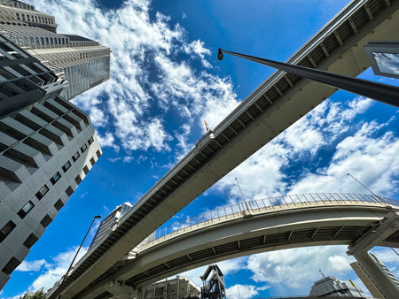 Shinjuku skyscrapers and highway, blue sky and white clouds, daytimeの写真素材