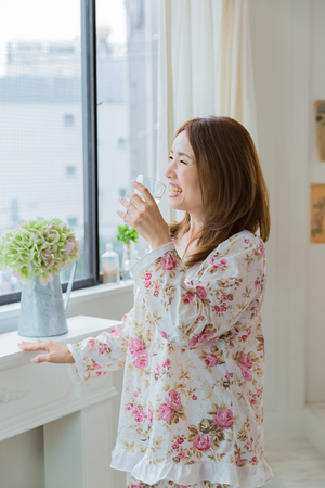 Lady drinking waterの写真素材