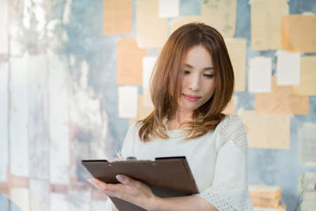 Lady holding clipboardの写真素材
