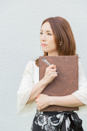Lady holding clipboardの写真素材