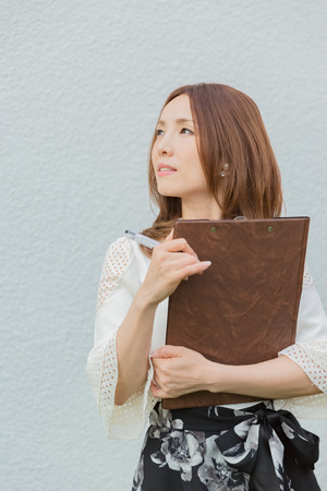 Lady holding clipboardの写真素材