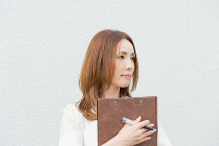 Lady holding clipboardの写真素材