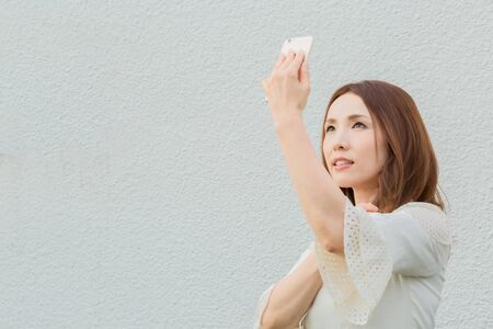 Lady taking pictures by her selfの写真素材