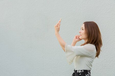 Lady taking pictures by her selfの写真素材