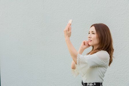 Lady taking pictures by her selfの写真素材