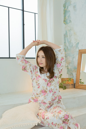 Lady in nightwear stretchingの写真素材