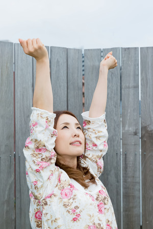 Lady in nightwear stretching outsideの写真素材