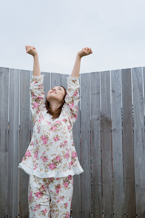 Lady in nightwear stretching outsideの写真素材