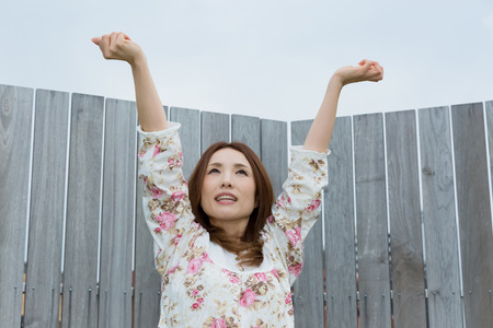 Lady in nightwear stretching outsideの写真素材