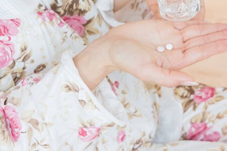 Lady swallowing pillsの写真素材