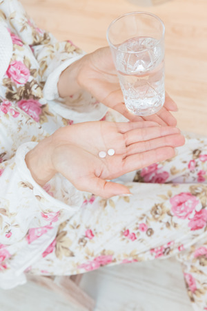 Lady swallowing pillsの写真素材