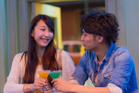 Couples drinking at bar counterの写真素材