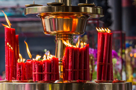 Burning red candle in Chinese templeの写真素材