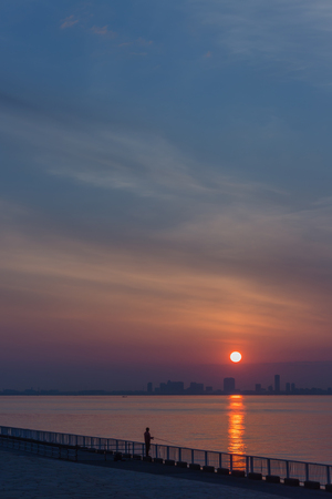 Sunrise in Tokyo Bay with fishermanの写真素材