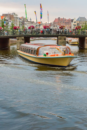 tour boat on canal in amsterdamのeditorial素材