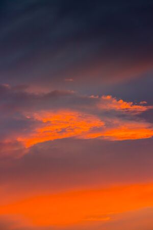 sunset sky with orange colored cloudの写真素材