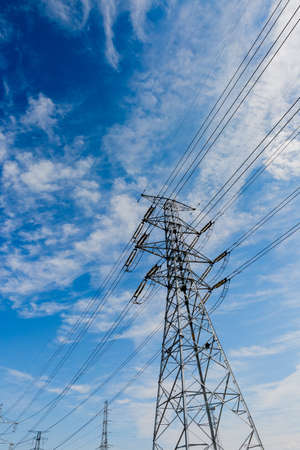 tower of electric transmission line with blue skyの写真素材
