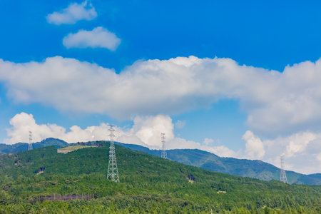 tower of electric transmission line with blue skyの写真素材