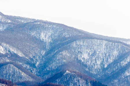 mountain covered with snow in winter seasonの写真素材