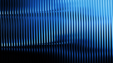 A dark blue corrugated metal sheet background features strong vertical lines and dramatic lighting, creating a visually striking and modern industrial aesthetic.の写真素材