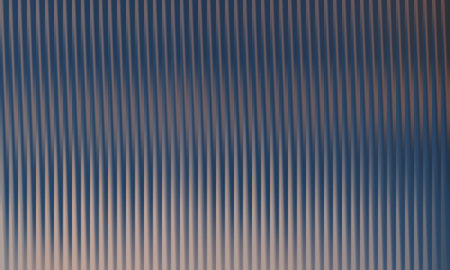 This is a close-up of a corrugated metal sheet featuring vertical lines and blurred reflections. The texture and pattern create an abstract and industrial background.の写真素材