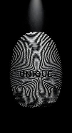 Fingerprint with the word unique on it in a spotlight on a black backgroundの素材