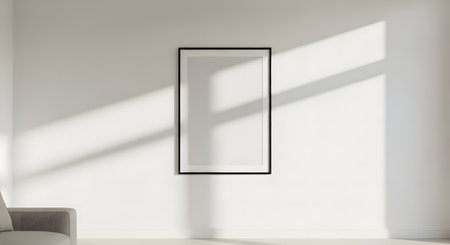Blank frame mockup on white wall with sunlight, perfect for artwork displayの素材
